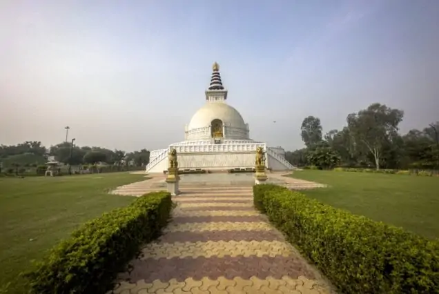 Pilgrims meditating at Mahaparinirvana Temple in Kushinagar during Buddha Spiritual Circuit Tour by Go India Holiday